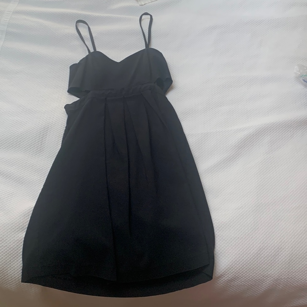 Sparkle and Fade little black dress with small feminine cutouts around the ribs